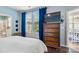 This main bedroom has dark wood floors, television, ensuite bathroom and adjacent dining area at 344 Linestowe Dr, Belmont, NC 28012