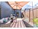 Cozy outdoor patio featuring comfortable seating and shaded by a large umbrella at 344 Linestowe Dr, Belmont, NC 28012