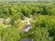 Aerial view of neighborhood home nestled among trees and landscaping at 405 N Woodland Dr, Lancaster, SC 29720