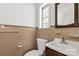 Classic bathroom featuring a toilet, sink and neutral colored tiles at 405 N Woodland Dr, Lancaster, SC 29720