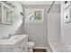 A clean and simple bathroom with white fixtures, gray walls, and a window for natural light at 405 N Woodland Dr, Lancaster, SC 29720