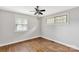 Neutral bedroom featuring hardwood floors, ceiling fan, and bright windows at 405 N Woodland Dr, Lancaster, SC 29720