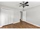Bedroom featuring hardwood floors, ceiling fan, and closet creating ample storage at 405 N Woodland Dr, Lancaster, SC 29720