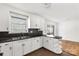 White cabinets and stylish breakfast bar in this quaint kitchen at 405 N Woodland Dr, Lancaster, SC 29720