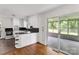Kitchen area featuring white cabinets and an adjacent sunroom at 405 N Woodland Dr, Lancaster, SC 29720