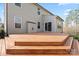 An expansive wooden deck leads to a home with sliding glass doors offering outdoor living space at 4095 Harmattan Dr, Denver, NC 28037