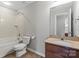 A bathroom features a vanity, bath tub, and toilet at 4095 Harmattan Dr, Denver, NC 28037