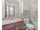 A bathroom features a vanity with granite countertop, white cabinets, and a shower-tub combination at 4095 Harmattan Dr, Denver, NC 28037