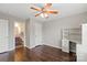 Bedroom featuring a ceiling fan, hardwood floors, built-in desk with shelves and a doorway to an ensuite bathroom at 4095 Harmattan Dr, Denver, NC 28037