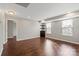 Neutral bedroom featuring hardwood floors, built-in shelves, and sunlit windows with bright natural light at 4095 Harmattan Dr, Denver, NC 28037