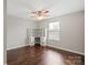 Bedroom with hardwood floors, ceiling fan, and a built-in desk and shelves area perfect for work from home at 4095 Harmattan Dr, Denver, NC 28037