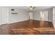 Bedroom with hardwood floors, neutral walls, multiple doors, and a floating shelf; lots of open space at 4095 Harmattan Dr, Denver, NC 28037