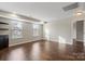 Bright bedroom with hardwood floors, recessed lighting, sunny windows and built-in shelves with dark wood accent cabinet at 4095 Harmattan Dr, Denver, NC 28037
