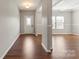 Inviting entryway featuring hardwood floors, neutral paint, and a decorative front door with glass detailing at 4095 Harmattan Dr, Denver, NC 28037