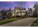 Charming two-story home featuring stone and siding exterior, well-manicured landscaping, and a spacious driveway at 4095 Harmattan Dr, Denver, NC 28037