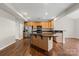 Well-lit kitchen with stainless steel appliances, black countertops, and center island at 4095 Harmattan Dr, Denver, NC 28037