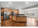 Spacious kitchen with stainless steel appliances, center island, and hardwood floors at 4095 Harmattan Dr, Denver, NC 28037