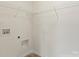 A laundry room features wall-mounted wire shelving and utility connections ready for appliances at 4095 Harmattan Dr, Denver, NC 28037