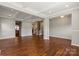 Open living room with hardwood floors, trey ceiling, and access to stairs at 4095 Harmattan Dr, Denver, NC 28037