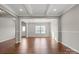 Bright living room featuring tray ceilings, hardwood floors, and large windows bringing in natural light at 4095 Harmattan Dr, Denver, NC 28037