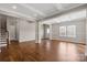 Open living room with hardwood floors, trey ceiling, and access to stairs at 4095 Harmattan Dr, Denver, NC 28037