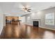 Spacious living room with hardwood floors, fireplace, and open layout to kitchen at 4095 Harmattan Dr, Denver, NC 28037