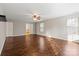 Large main bedroom with hardwood floors, neutral walls, a ceiling fan, and ensuite bathroom access at 4095 Harmattan Dr, Denver, NC 28037
