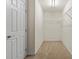 A closet features neutral carpeting, wire shelving, and a light fixture for organized storage at 4095 Harmattan Dr, Denver, NC 28037