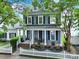Inviting two-story home featuring a cozy front porch, traditional shutters, and lovely landscaping at 436 Third Baxter St, Fort Mill, SC 29708