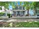 Charming two-story home with a welcoming front porch, classic white picket fence, and lush green lawn at 436 Third Baxter St, Fort Mill, SC 29708