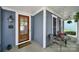 Inviting covered front porch with a wooden door, seating area, and decorative accents at 436 Third Baxter St, Fort Mill, SC 29708