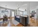 Kitchen island with a white farmhouse sink and stainless steel dishwasher overlooking the living room at 436 Third Baxter St, Fort Mill, SC 29708