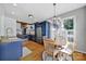 Open kitchen and breakfast area featuring blue cabinets, stainless appliances, and natural light at 436 Third Baxter St, Fort Mill, SC 29708