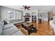 Comfortable living room featuring a brick fireplace, ceiling fan, and hardwood floors at 436 Third Baxter St, Fort Mill, SC 29708