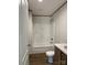 Bathroom featuring a shower-tub, toilet, and sink with marble countertop at 493 Eagle Mills Rd, Hamptonville, NC 27020