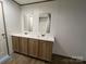 Bathroom featuring dual sinks, tub, neutral wall color, and wood-look floors at 493 Eagle Mills Rd, Hamptonville, NC 27020