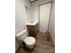 Modern bathroom featuring toilet, vanity, and wood-look floors at 493 Eagle Mills Rd, Hamptonville, NC 27020