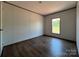 Bright bedroom features wood-look flooring and ample natural light from a window at 493 Eagle Mills Rd, Hamptonville, NC 27020