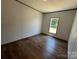 Bedroom boasts wood-look flooring and natural light from window at 493 Eagle Mills Rd, Hamptonville, NC 27020