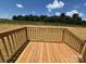 New wooden deck overlooking a vast, picturesque landscape under a bright blue sky at 493 Eagle Mills Rd, Hamptonville, NC 27020