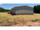 Side exterior view of gray home featuring a back porch with steps at 493 Eagle Mills Rd, Hamptonville, NC 27020