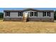 Front exterior view of a charming gray home with black shutters at 493 Eagle Mills Rd, Hamptonville, NC 27020