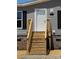 Close up of front door with wooden steps and black shutters at 493 Eagle Mills Rd, Hamptonville, NC 27020