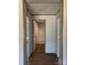 Bright hallway with hardwood floors leading to a modern, clean bathroom at 493 Eagle Mills Rd, Hamptonville, NC 27020