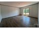 Bright living room featuring wood-look floors, natural light, and neutral wall color at 493 Eagle Mills Rd, Hamptonville, NC 27020