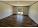 Bright living room featuring wood-look floors, natural light, and neutral wall color at 493 Eagle Mills Rd, Hamptonville, NC 27020