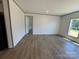 Bright living room featuring wood-look floors, natural light, and neutral wall color at 493 Eagle Mills Rd, Hamptonville, NC 27020