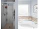 Bright bathroom with a tiled tub and shower, offering a serene and modern space at 5003 Singletree Ln, Indian Trail, NC 28079