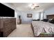 Spacious bedroom features neutral carpet, ceiling fan, and arcade game for entertainment at 5003 Singletree Ln, Indian Trail, NC 28079