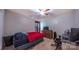 A bedroom with a TV, fan, desk, and large window for natural light at 5003 Singletree Ln, Indian Trail, NC 28079